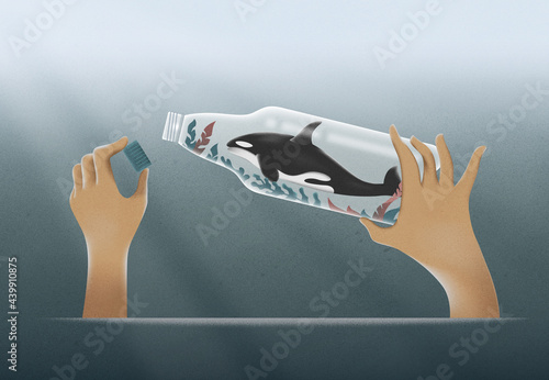 Woman unscrew the lid off a plastic bottle with a  killer whale. 