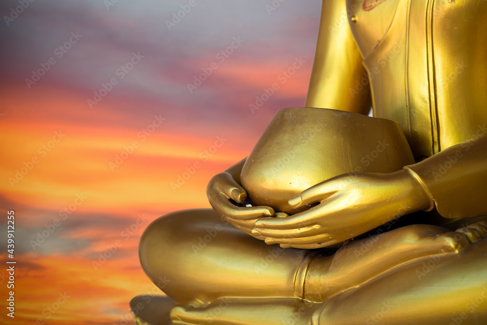 Close up old Buddha statue with raw of Brass. Hand of buddha statue holding monk's alms bowl with line. Believe, Culture. Buddhist believe and merit. Calm and meditation concept. Copy space.