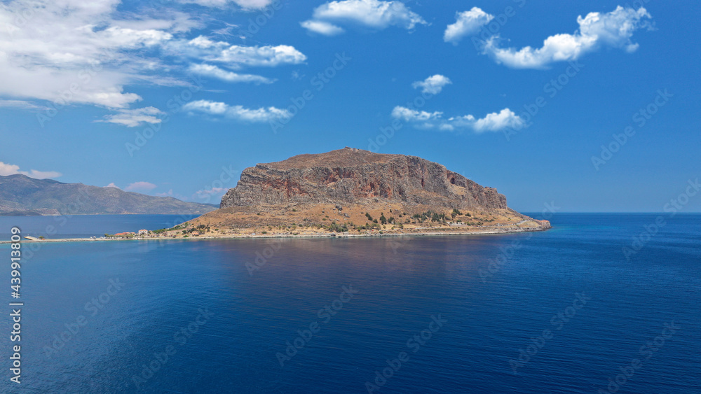 Fototapeta premium Aerial drone photo of beautiful castle and medieval old city of Monemvasia in the heart of Lakonia with beautiful clouds and deep blue sky, Peloponnese, Greece