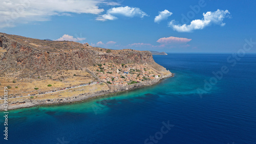 Aerial drone photo of beautiful castle and medieval old city of Monemvasia in the heart of Lakonia with beautiful clouds and deep blue sky, Peloponnese, Greece © aerial-drone