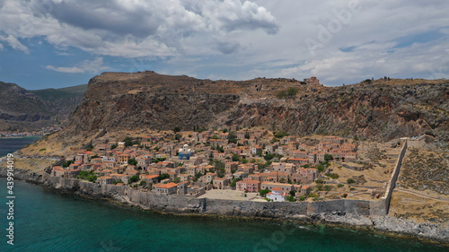 Aerial drone photo of beautiful castle and medieval old city of Monemvasia in the heart of Lakonia with beautiful clouds and deep blue sky, Peloponnese, Greece