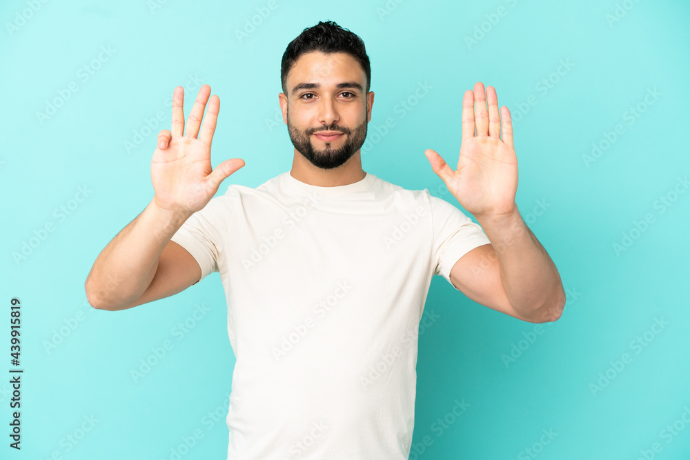 Young arab man isolated on blue background counting nine with fingers Young arab man isolated on blue background counting nine with fingers
