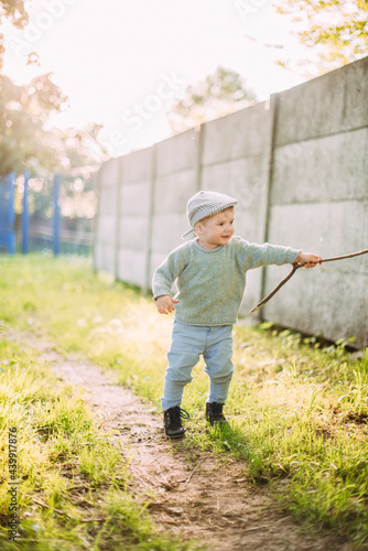 Cute and handsome baby boy 1-2 years old exploring nature in summer, having fun