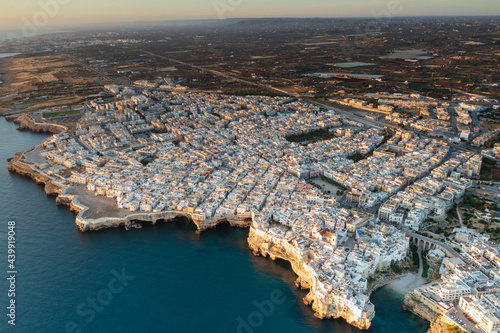 Aerial view of a sunrise in Polinano by sea. A seaside village in Bari, Puglia