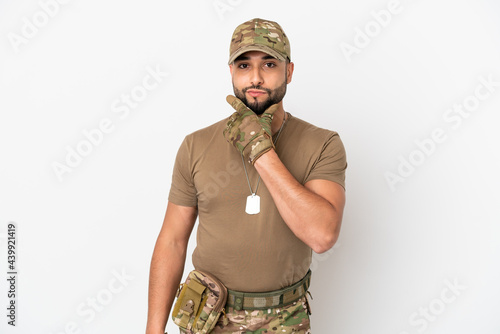 Young arab soldier man isolated on white background thinking photo