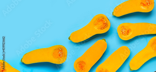 Cut butternut squash on blue background.