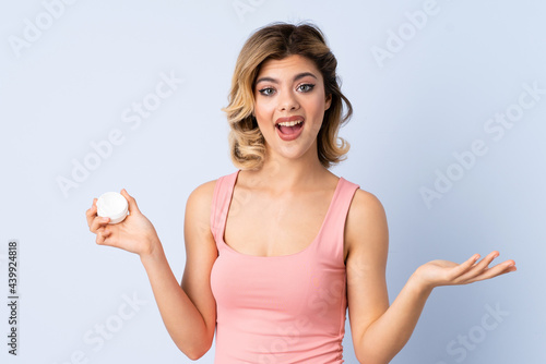 Young girl with moisturizer with shocked facial expression