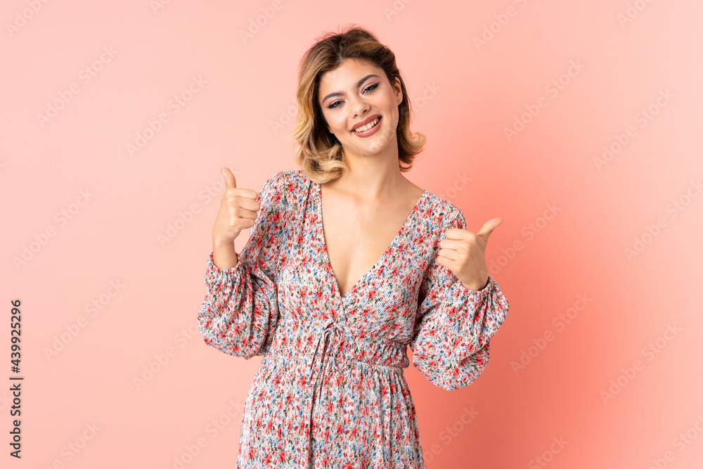 Young Russian woman isolated on pink background giving a thumbs up gesture Young Russian woman isolated on pink background giving a thumbs up gesture