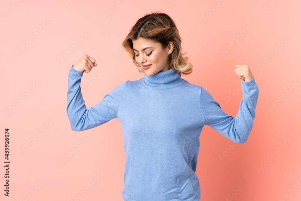 Young Russian woman isolated on pink background doing strong gesture Young Russian woman isolated on pink background doing strong gesture