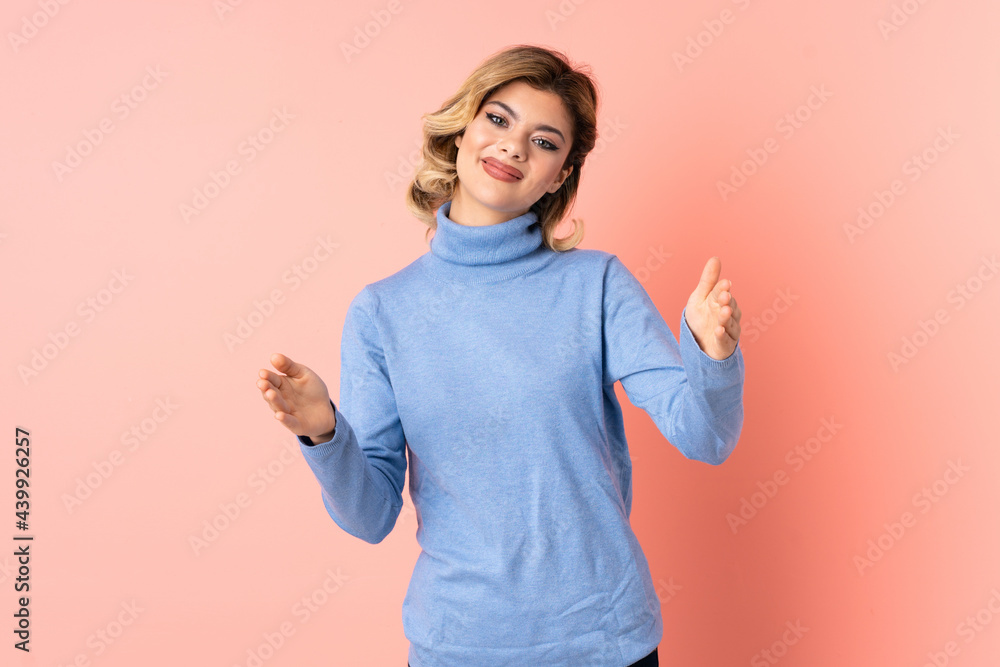 Young Russian woman isolated on pink background presenting and inviting to come with hand Young Russian woman isolated on pink background presenting and inviting to come with hand