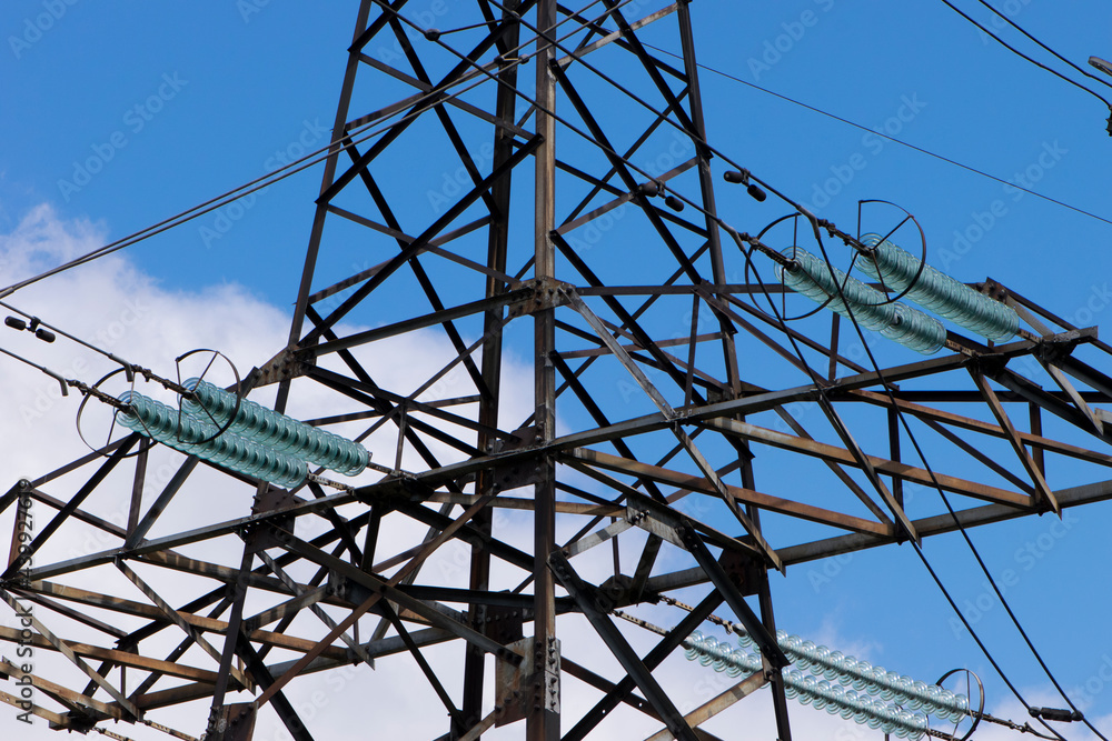 power line of cables and insulators close up. electrical insulators support cables placed on bracket installed on power pole. Clear blue sky without cloud background. Concept of industrial power line of cables and insulators close up. electrical insulators support cables placed on bracket installed on power pole. Clear blue sky without cloud background. Concept of industrial