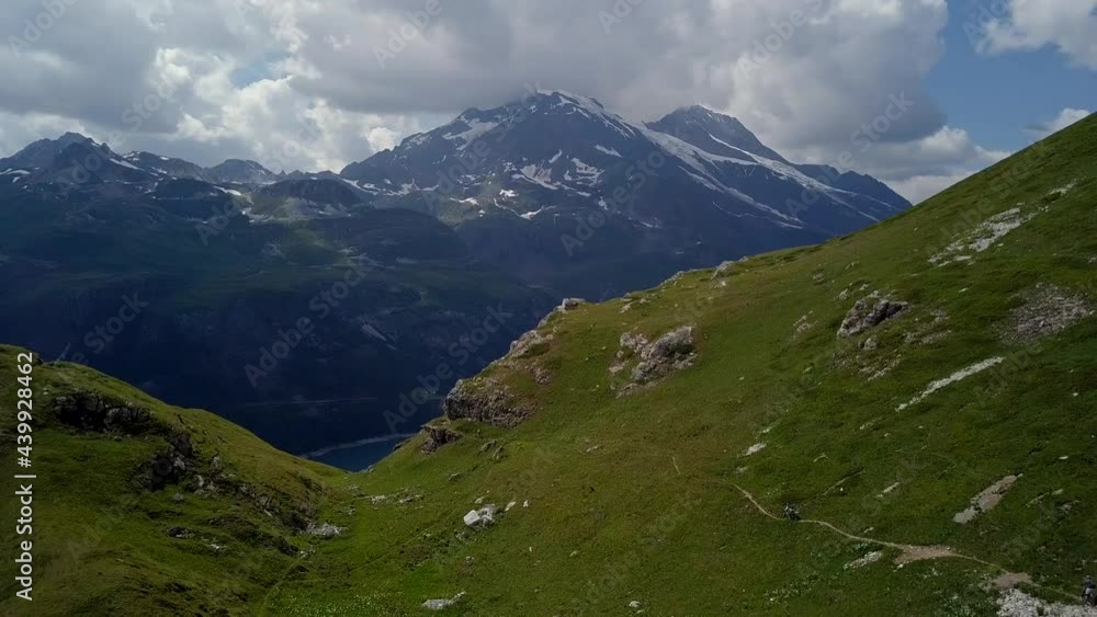Mountain biker on trail in alps aerial flight - 4k UHD Mountain biker on trail in alps aerial flight - 4k UHD