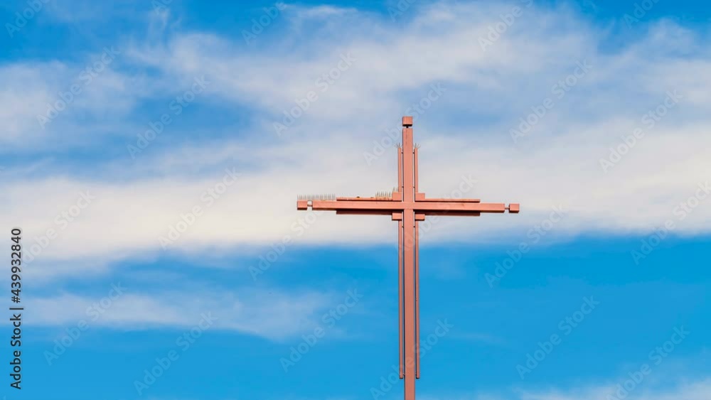 A church cross framed with moving clouds shows the excitement of a deity being present as people pray during a Sunday gathering. A church cross framed with moving clouds shows the excitement of a deity being present as people pray during a Sunday gathering.