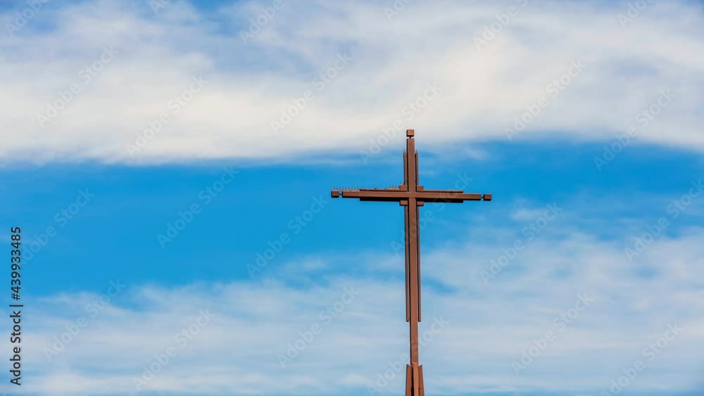 A church cross framed with moving clouds shows the excitement of a deity being present as people pray during a Sunday gathering. A church cross framed with moving clouds shows the excitement of a deity being present as people pray during a Sunday gathering.