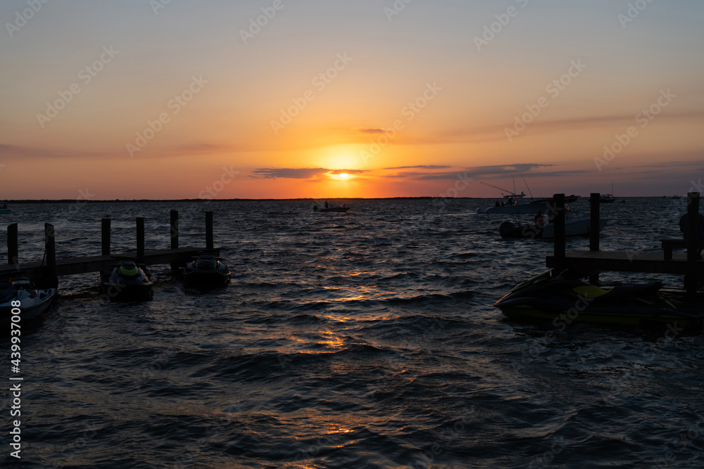 romantic sundown seascape with silhouette pier jet ski and yacht boats, summer vacation. romantic sundown seascape with silhouette pier jet ski and yacht boats, summer vacation.