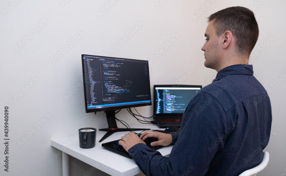 Male programmer working from home. Male hands are typing the code. Technology and homework concept Male programmer working from home. Male hands are typing the code. Technology and homework concept