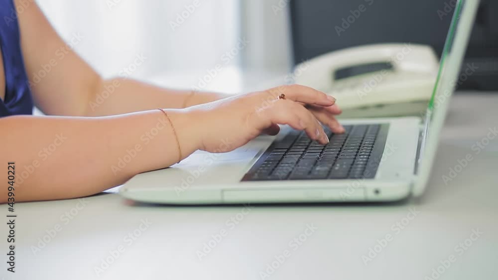 Woman hands are typing on laptop keyboard in home office Woman hands are typing on laptop keyboard in home office