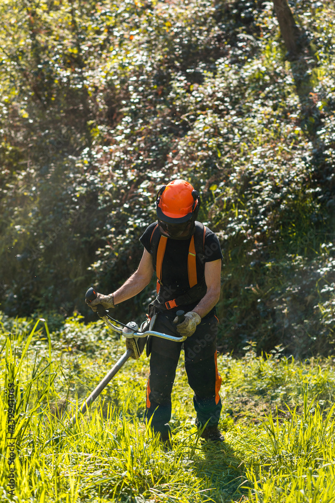 Farmer mowing grass in countryside using lawn mower Farmer mowing grass in countryside using lawn mower