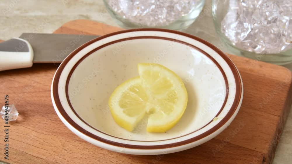 Sliced lemon disappearing from a small bowl on a cutting board, stop motion animation Sliced lemon disappearing from a small bowl on a cutting board, stop motion animation