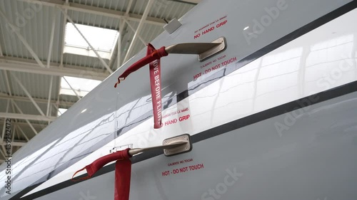 Steady gimbal movement around jet plane, covered pitot tube in hangar photo