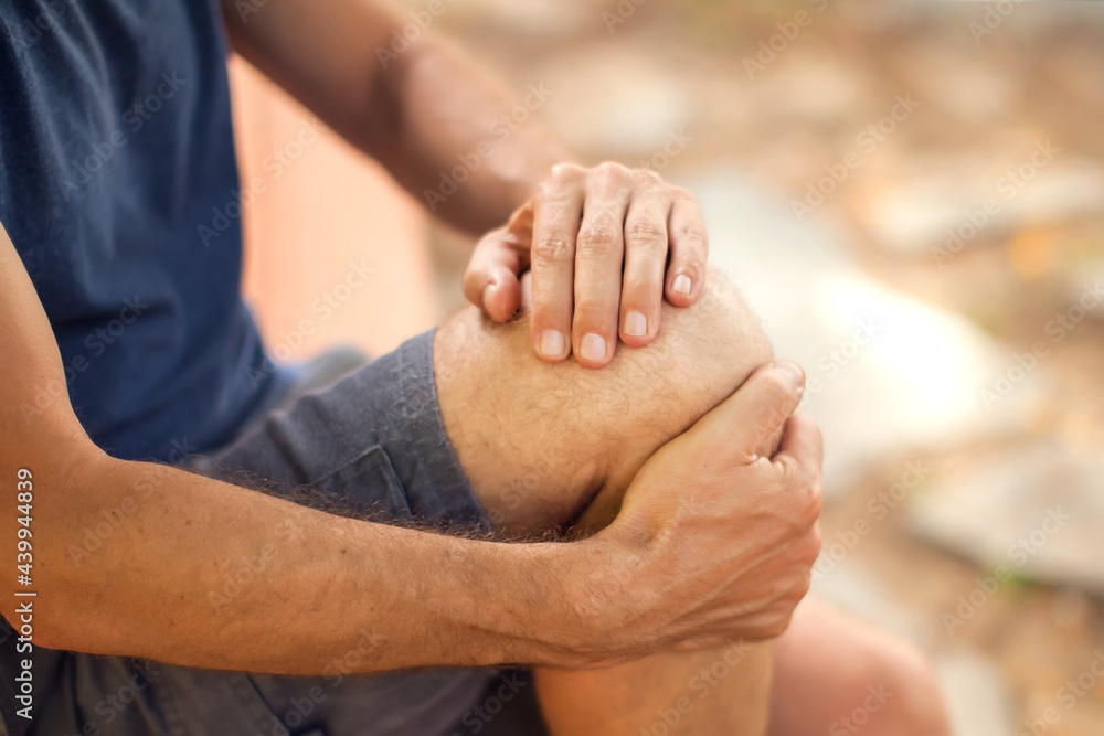 Fototapeta premium Man with knee pain outdoor. Healthcare and medicine concept