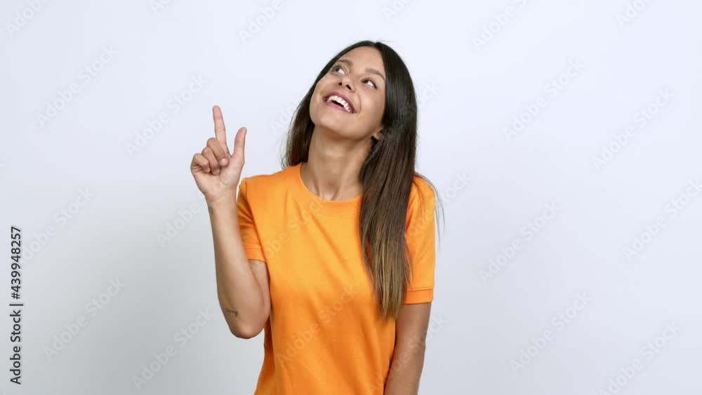 Young woman pointing a great idea and looking up over isolated background Young woman pointing a great idea and looking up over isolated background