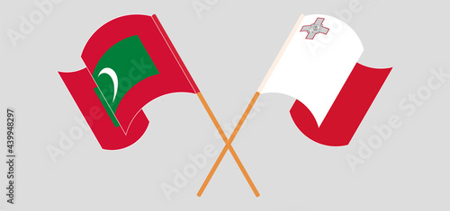 Crossed and waving flags of Maldives and Malta