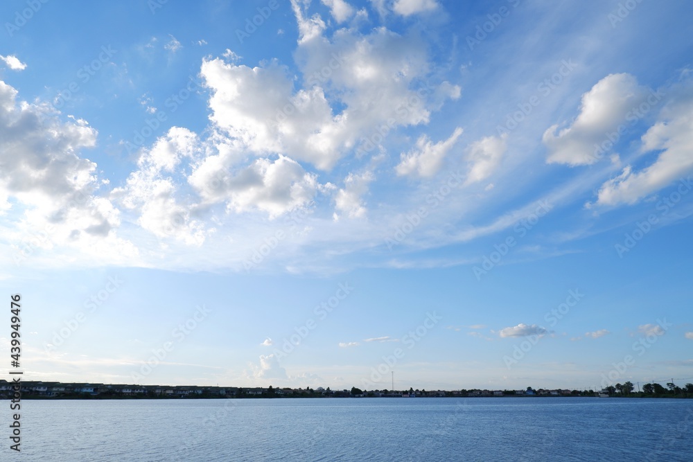 blue sky with white clouds on river on natural light background blue sky with white clouds on river on natural light background
