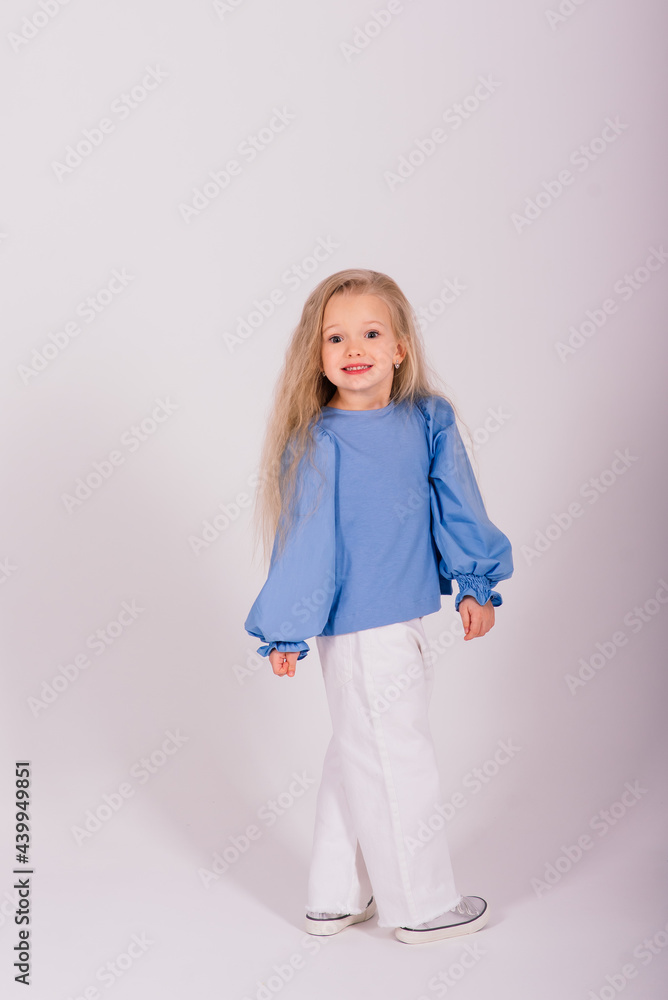 Portrait of a cheerful girl jumping and dancing against a studio background Portrait of a cheerful girl jumping and dancing against a studio background