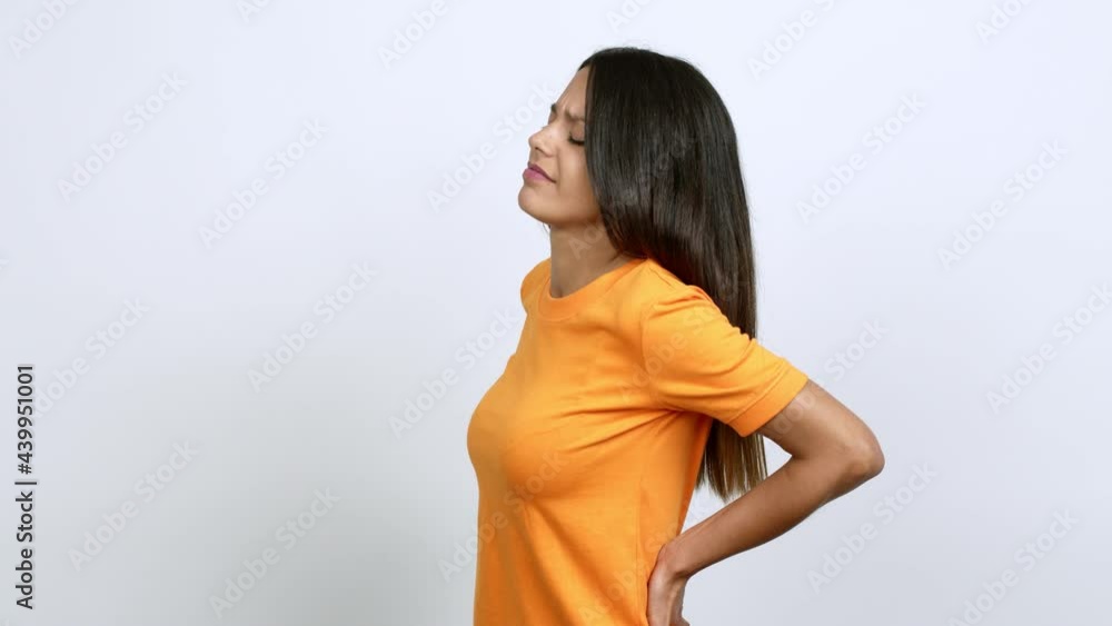 Young woman suffering from pain in shoulder for having made an effort over isolated background Young woman suffering from pain in shoulder for having made an effort over isolated background