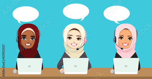 Three beautiful muslim female call center workers at office with headsets customer support concept