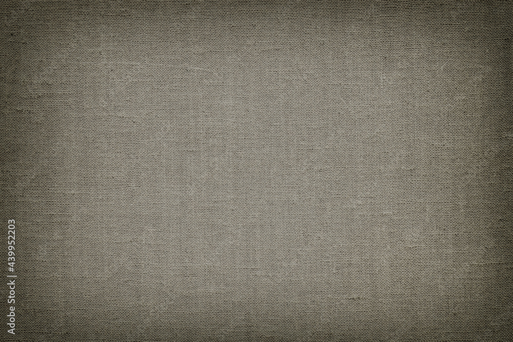 Fototapeta premium Natural canvas, sackcloth, dark grey color. Close-up of jute texture pattern with vignette, vintage background