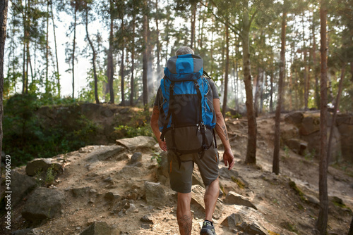 Selective focus on caucasian man with tourist backpack