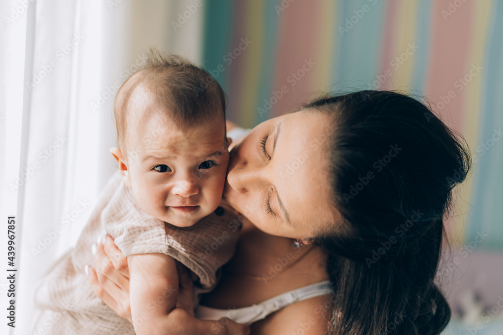 Young mother hugs her mixed race child. Child adoption and In Vitro Fertilization IVF Young mother hugs her mixed race child. Child adoption and In Vitro Fertilization IVF