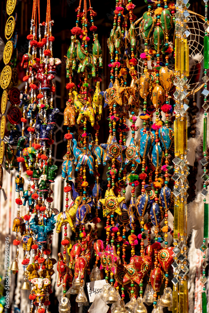 Hanging ornaments with Indian figures and colored charms to decorate interiors. Arts, decoration concept.