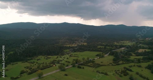 Aerial view of traffic, driving on a countryside road, in Slovenia - tracking, tilt, drone shot photo