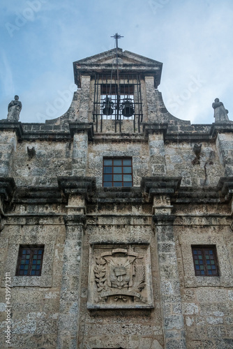 Dramatic image of a old weathered stone facade of a church in the colonial district of downtown Santo Domingo in the Dominican Republic 