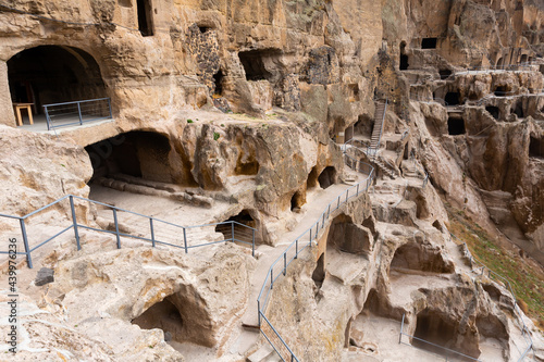 Complex of cave monastery structures carved into mountain in historic city of Vardzia, important archaeological site and tourist attraction in Georgia..