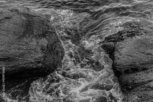 Image of rock formations (stones), with texture and sharpness, on the beach during the day photo