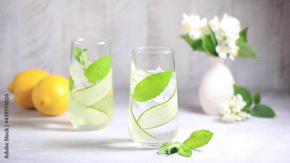 The process of making detox water with cucumber, mint and lemon juice. The process of making detox water with cucumber, mint and lemon juice.