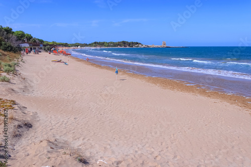 Sfinale Beach, between Peschici and Vieste, with an ancient Torre Saracena, typical lookout tower of the coast of Gargano in Apulia, Italy. photo