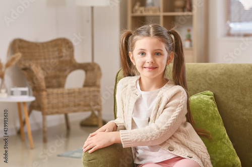 Cute little girl sitting on...
