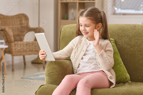 Little girl using tablet co...