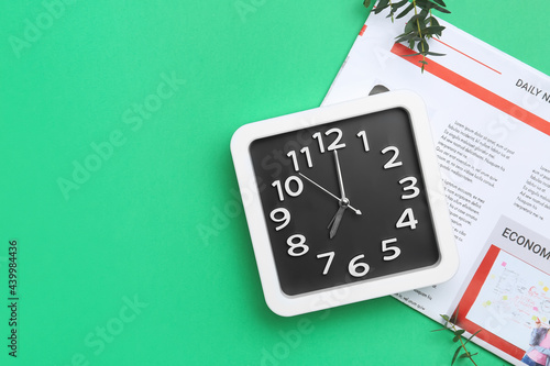 Stylish clock and newspaper...