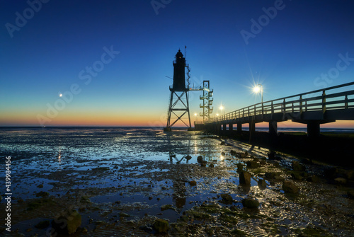 scenic evening view of the historic lighthouse "Obereversand" in Dorum-Neufeld (Germany) during the blue hour