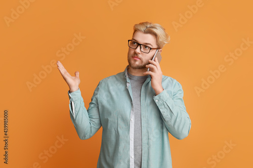 Handsome man talking by mob...