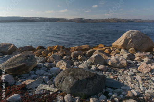 The shore of the bay and many large stones .