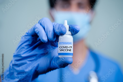 Close up Hands of Doctor or nurse holding Intranasal vaccine spary bottle for coronavirus or covid-19 pandemic