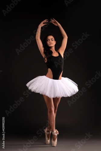 Pretty ballerina in tutu stand on pointess