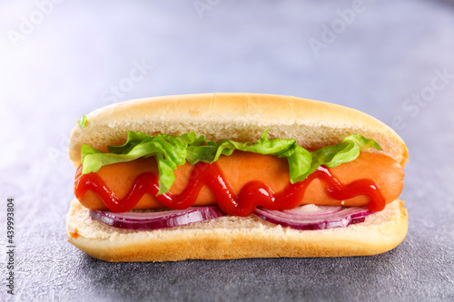 hot dog with sausage, lettuce and ketchup